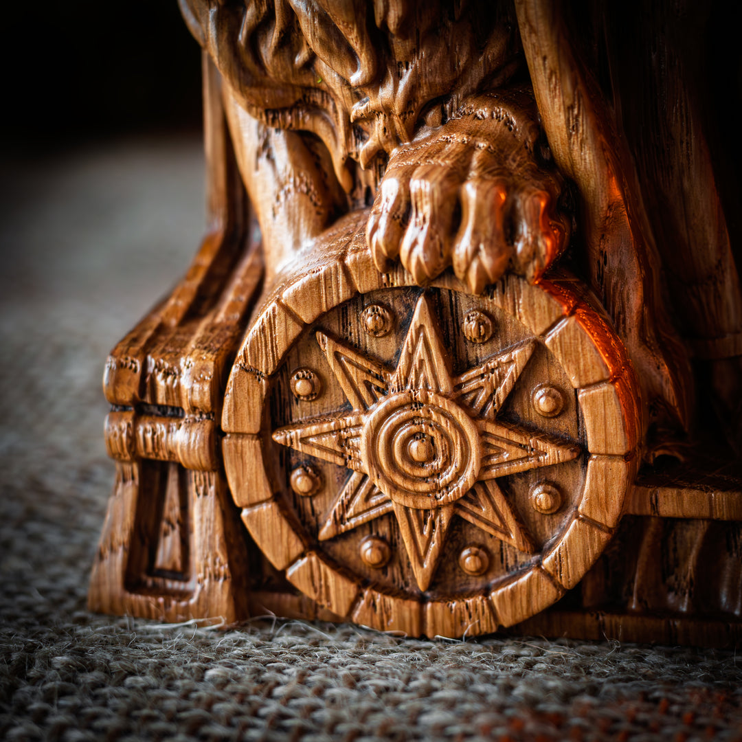 Close-up of Ishtar statue’s lion paw resting on a carved Mesopotamian star-wheel.