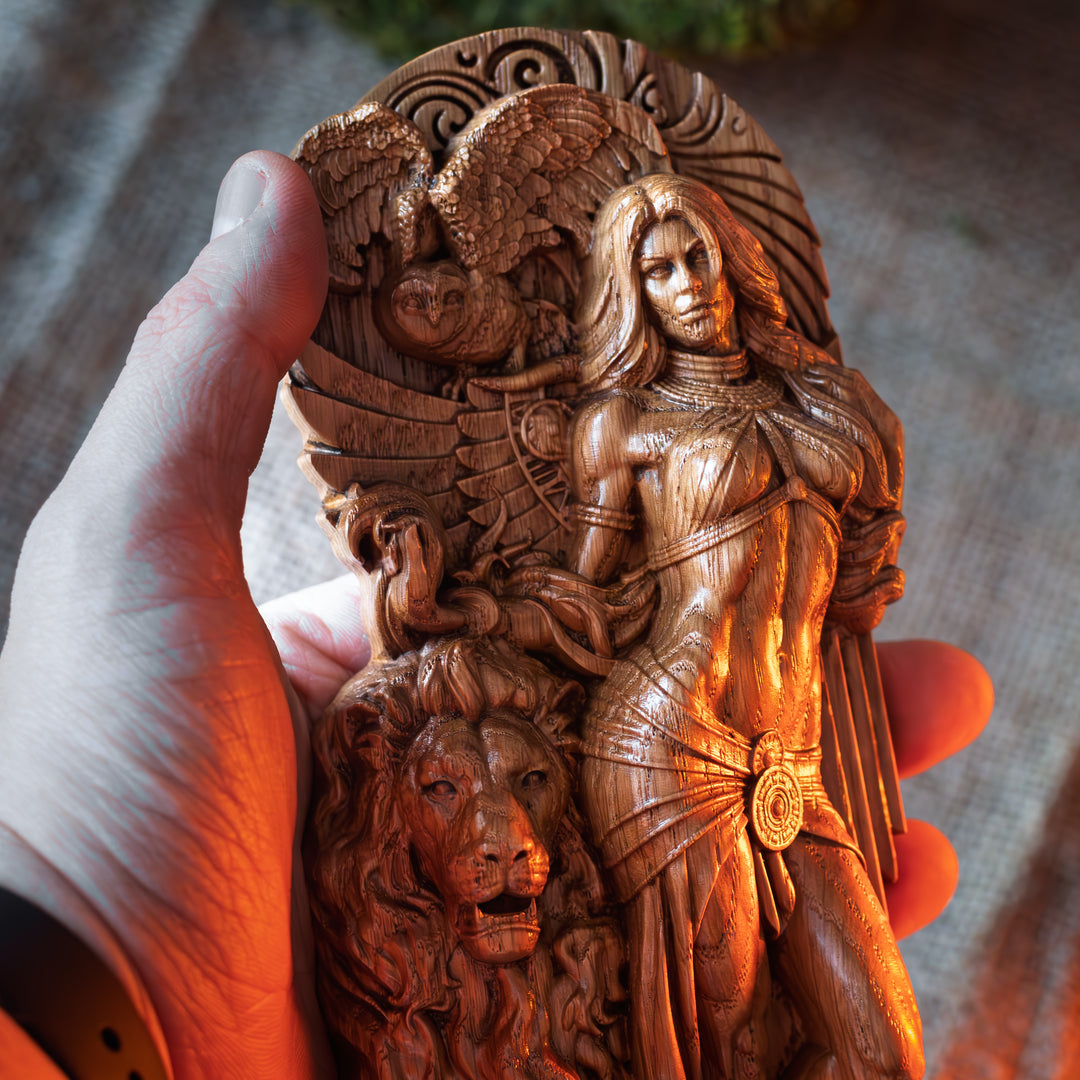  Hand holding the wooden statue of Ishtar to demonstrate size and intricate craftsmanship.