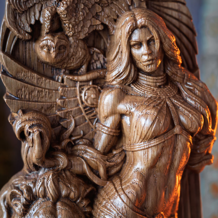 Close-up of the upper part of the Ishtar statue highlighting her face, torso, and owl wings in the background.